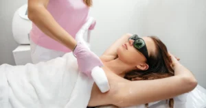 Woman receiving underarm Laser Hair Removal in Kearney, NE from a technician wearing pink gloves.
